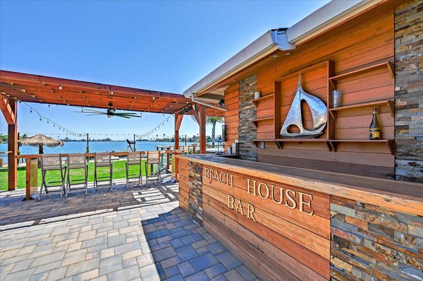 Complete Landscaping Overhaul! - A shaded outdoor kitchen & bar with a deck, and a fire pit area & hardscaped bench Complete Landscaping Overhaul! - A shaded outdoor kitchen & bar with a deck, and a fire pit area & hardscaped bench