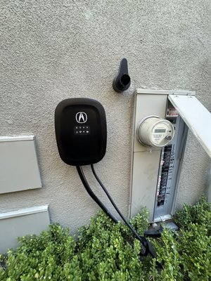 Acura EV Charger Installation with New 50A Breaker - This project was a full installation of a new Acura EV charger on the exterior of the home. The customer needed a dedicated 50-amp circuit added to an already crowded panel, along with a clean and safe wiring route from the panel to the new charging unit.
We installed a new 50-amp breaker labeled for EV charging, ran a fully protected exterior conduit line, and mounted the charger securely with a weather-rated finish. The wiring was kept low-profile and blended into the home’s exterior for a clean look. All terminations were tightened, tested, and verified under load to make sure the charging system performs safely and reliably.
The final setup gives the homeowner fast Level 2 charging, a clean installation, and a dedicated circuit built to handle the charger’s demand with no stress on the rest of the electrical system. Acura EV Charger Installation with New 50A Breaker - This project was a full installation of a new Acura EV charger on the exterior of the home. The customer needed a dedicated 50-amp circuit added to an already crowded panel, along with a clean and safe wiring route from the panel to the new charging unit.
We installed a new 50-amp breaker labeled for EV charging, ran a fully protected exterior conduit line, and mounted the charger securely with a weather-rated finish. The wiring was kept low-profile and blended into the home’s exterior for a clean look. All terminations were tightened, tested, and verified under load to make sure the charging system performs safely and reliably.
The final setup gives the homeowner fast Level 2 charging, a clean installation, and a dedicated circuit built to handle the charger’s demand with no stress on the rest of the electrical system.
