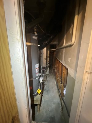 Commercial Mold Remediation - A water heater leak caused mold growth at the base of the drywall inside the mechanical closet and on the adjacent room’s drywall. Water also traveled beneath the wood flooring in the adjacent room, leading to buckling. All Hands arranged asbestos testing, removed the affected drywall, completed a detailed mold remediation, and dried the affected areas, all within three days.