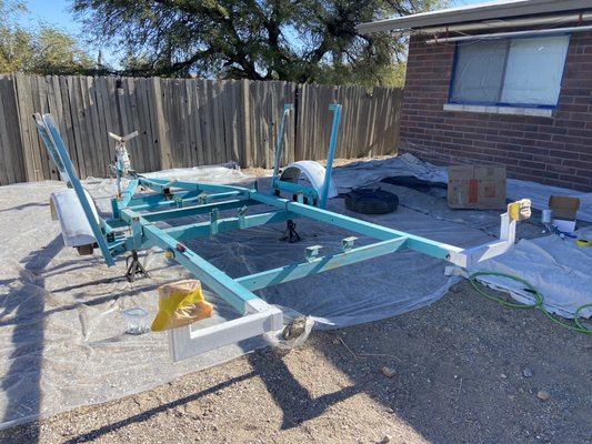 Full Sailboat and Trailer HVLP Paint Job - This old 22ft sailboat and trailer needed a big paint job overhaul and we took care of it every step of the way and even added new custom racing stripes to it!