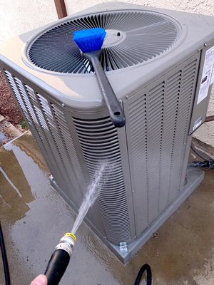 Tune up cleaning for AC system - Technician getting customers AC ready for summer Tune up cleaning for AC system - Technician getting customers AC ready for summer