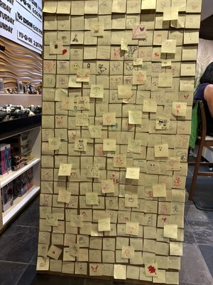Solano Stroll Artwork 2024 - At Solano Stroll 2024, we offered sticky notes and drawing implements to anyone who wanted to trade an "original drawing" for a wheel spin for prizes. Those drawings went up in the window of our store in the El Cerrito Plaza!