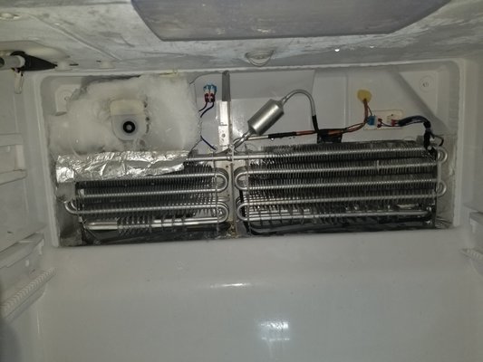 The evaporator fan motor is broken - Had a visit with refrigerator issue that did not cool at all into freezer compartment, after disassembly freezer evaporator cover, we saw the fan motor did not work at all and build up with ice. Fan motor replacement solve that issue.