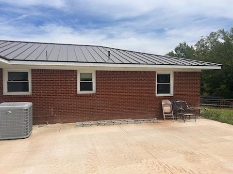 Gutter installation on residence - Installed seamless gutters and downspouts to reroute water away from patio.