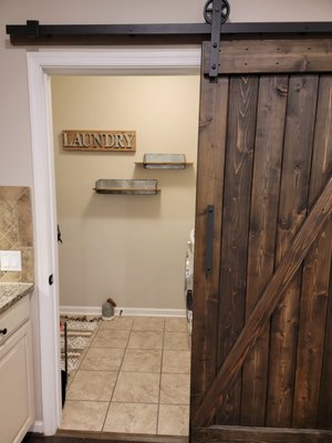 Barn Door w/shelves - The door was custom built, stained, and mounted on the kitchen-to-laundry room walkway. Barn Door w/shelves - The door was custom built, stained, and mounted on the kitchen-to-laundry room walkway.