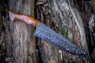 Bowie Knife By "Feathered Knife Works" - Handforged & Handmade by Luke Sparrow of Feathered Knife Works
Steel is Bakerforge and Tool Chevron Damascus with Wrought Iron Clad, Copper shim & 80crv2 core.
Handle is made from a book matched set of highly figured desert ironwood burl, using 5 brass pins and one brass/copper mosaic pin.
Knife includes custom handmade Leather sheath. Bowie Knife By "Feathered Knife Works" - Handforged & Handmade by Luke Sparrow of Feathered Knife Works
Steel is Bakerforge and Tool Chevron Damascus with Wrought Iron Clad, Copper shim & 80crv2 core.
Handle is made from a book matched set of highly figured desert ironwood burl, using 5 brass pins and one brass/copper mosaic pin.
Knife includes custom handmade Leather sheath.