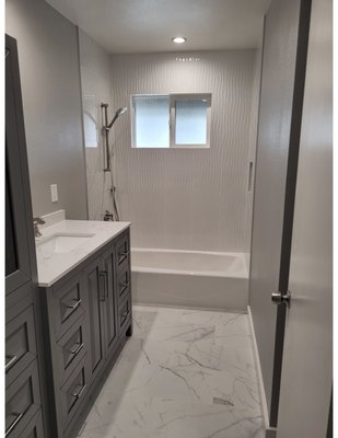 Textured walls on tub shower with quartz flooring - Textured walls on tub shower with quartz flooring.