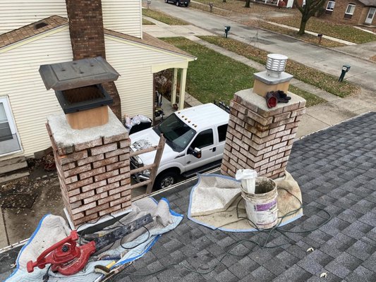 Utica Chimney Rebuild - Close and Wide Photos of twin chimney rebuild in utica. Phot was taken after grinding and clean up. new caps were added. Now time to do the repointing.