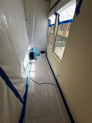 Mold Remediation in San Clemente , CA - Mold growth was found on the baseboards and drywall in the living room, though no moisture was initially detected. The suspected cause was water intrusion from the exterior stucco. The homeowner received proposals for both standard water damage remediation and advanced mold remediation (AMRT).

Upon arrival, containment was set up, floor protection was placed, and affected drywall, baseboards, and insulation were removed. The exposed framing was HEPA vacuumed, treated with antimicrobial, and drying equipment was installed. A water test on the exterior revealed water intrusion from an improperly sealed outlet and the weep screed.

After exterior repairs were completed, a second water test confirmed no further water entry, indicating the repairs were successful. The interior is now ready for restoration.