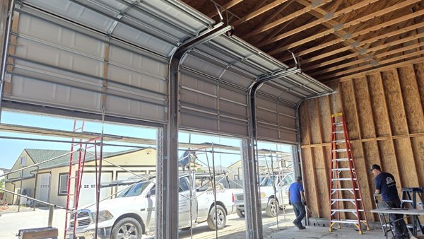 High Lift Conversion - This conversion is ideal for garages with high ceilings, automotive lifts, workshops, commercial buildings, and homeowners looking to maximize their usable space.

Benefits of a High-Lift Conversion:

Maximizes overhead clearance and available garage space

Ideal for car lifts, storage, and workshop applications

Reconfigures the garage door's track system for a higher vertical lift

Includes necessary high-lift hardware and spring system modifications based on door specifications

Customized to fit the existing garage door and available ceiling height

Professional installation for safe, reliable operation