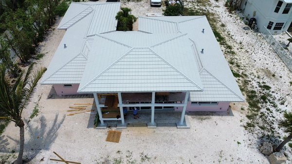 Beach House Worthouse 200mph Metal Tile - This house was affected by a hurricane and had an aging Tile Roof on it. The homeowner decided to replace it with a Warehouse metal roof with a 200 mph warranty.