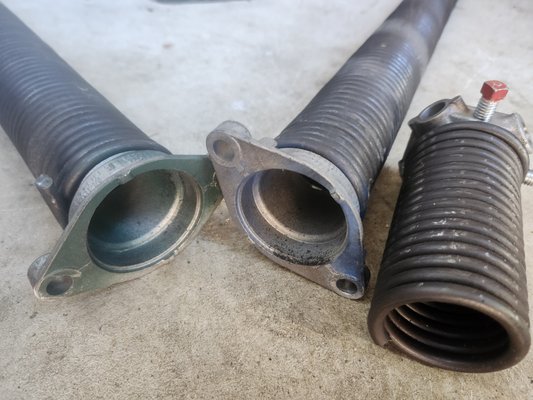 Garage Door Spring Repair - CAUTION...Two different coil sizes! This means improper balance of the door causing strain and damage to the opener by having to work against the springs tension force, lift and push more weight than it should. This also means the counter balance of the springs is not correct, which will shorten the life span of the springs causing the garage door to come crashing down when it breaks.
Call Honest Garage Doors and have the peace of mind the job will be done right! Garage Door Spring Repair - CAUTION...Two different coil sizes! This means improper balance of the door causing strain and damage to the opener by having to work against the springs tension force, lift and push more weight than it should. This also means the counter balance of the springs is not correct, which will shorten the life span of the springs causing the garage door to come crashing down when it breaks.
Call Honest Garage Doors and have the peace of mind the job will be done right!