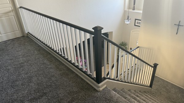 Stair Rail Upgrades - 
Natural wood to modern color. - The old stair rail was worn from years of use. We sanded down all surfaces removing years of built up dirt. We then painted the balusters white. The posts and hard rails were painted  black for a modern contrasting look.