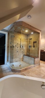 Master bathroom remodel in East Cobb GA - Welcome to our latest masterpiece in luxurious home design—a stunning master bathroom with an adjoining walk-in closet that exemplifies elegance and functionality. This space is designed to offer the ultimate in comfort and style, featuring a range of premium amenities that cater to your every need.

Features:
Steam Shower: Indulge in a spa-like experience with our state-of-the-art steam shower, designed to provide relaxation and rejuvenation at the touch of a button.

Three Vanities: Enjoy ample space and convenience with three beautifully crafted vanities.

Heated Floors: Experience the luxury of warm floors, even on the coldest days. Our heated flooring system ensures your feet stay cozy and comfortable, adding an extra layer of indulgence to your daily routine.

Walk-In Closet: Adjacent to the master bathroom, the spacious walk-in closet offers organized storage solutions for all your wardrobe essentials. Custom shelving, drawers, and hanging spaces are meticulously designed to keep everything in its place.

This master bathroom is not just a place to start and end your day; it's a personal retreat. Every detail has been carefully considered to create an environment that exudes sophistication and comfort.

Explore the pictures in our portfolio to see the transformation of this space and imagine the possibilities for your own home. At CRM Construction & Renovation, we bring your dream spaces to life with unparalleled craftsmanship and attention to detail.