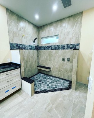 Tile Installation / Bathroom Remodel - High-quality tile installation and bathroom remodels are essential for achieving a stylish, functional, and durable space. Here are some key elements and considerations for achieving such results:

Professional Design: A successful bathroom remodel starts with a well-thought-out design plan. Consider factors such as layout, functionality, aesthetics, and the needs of the users. Professional designers can help create a cohesive vision that maximizes space and efficiency.

Quality Materials: Selecting high-quality tiles is crucial for durability and aesthetics. Porcelain, ceramic, and natural stone tiles are popular choices for bathrooms due to their durability and water resistance. Ensure that the chosen tiles are suitable for wet environments and meet your aesthetic preferences.

Proper Preparation: Proper preparation of the bathroom space is essential for a successful tile installation. This includes ensuring a level and stable subfloor, addressing any moisture issues, and applying waterproofing membranes in areas prone to water exposure such as shower walls and floors.

Skilled Installation: Tile installation requires precision and skill to achieve professional results. Hiring experienced tile installers ensures that tiles are properly laid, spaced, and grouted for a seamless finish. Attention to detail is crucial, especially around corners, edges, and transitions.

Waterproofing: Effective waterproofing is critical in bathrooms to prevent water damage and mold growth. Installing waterproof membranes, such as cement backer boards or waterproofing membranes, beneath the tile surface helps protect the underlying structure from moisture penetration.

Attention to Detail: High-quality bathroom remodels pay attention to the finer details, such as properly aligned grout lines, consistent tile spacing, and neatly finished edges. These details contribute to the overall aesthetic appeal and longevity of the installation.

Finishing Touches: The finishing touches, such as coordinating fixtures, hardware, lighting, and accessories, enhance the overall look and functionality of the bathroom. Choose high-quality fixtures and finishes that complement the tile design and contribute to the cohesive aesthetic of the space.

Proper Maintenance: Educate homeowners on the proper maintenance procedures to prolong the life and beauty of their newly remodeled bathroom. This includes regular cleaning and sealing of tiles and grout, as well as addressing any issues promptly to prevent damage.

By focusing on these key elements and working with experienced professionals, homeowners can achieve high-quality tile installation and bathroom remodels that enhance the beauty, functionality, and value of their homes.