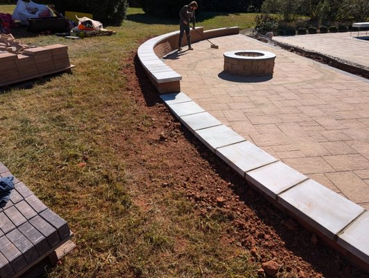 pool patio - the original pool and square patio around it was already there and I was called in to add the additional half circle patio, fire pit, and retaining wall