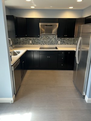 Kitchen Remodel - This townhome kitchen transformation focused on creating a brighter, more open aesthetic. We professionally sanded and refinished the original dark cabinets in a crisp white to modernize the space. To further enhance the open-concept feel, we removed the heavy upper cabinets and installed custom floating wood shelves, providing a contemporary storage solution without sacrificing functionality. The result is a clean, bright, and inviting space tailored to the client’s vision. Kitchen Remodel - This townhome kitchen transformation focused on creating a brighter, more open aesthetic. We professionally sanded and refinished the original dark cabinets in a crisp white to modernize the space. To further enhance the open-concept feel, we removed the heavy upper cabinets and installed custom floating wood shelves, providing a contemporary storage solution without sacrificing functionality. The result is a clean, bright, and inviting space tailored to the client’s vision.