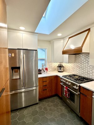 Kitchen Remodel - 2023 - This kitchen remodel features fully custom cabinets as well as a custom hood. New tile floors and backsplash complete the updated look and the waterfall countertop really shows a modern touch! Kitchen Remodel - 2023 - This kitchen remodel features fully custom cabinets as well as a custom hood. New tile floors and backsplash complete the updated look and the waterfall countertop really shows a modern touch!