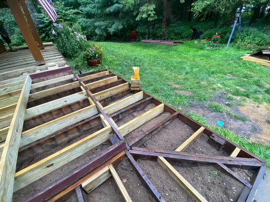 New composite deck in New Era, MI - This was a Re-deck project in New Era. The old decking had 2 foot spacing that allowed a lot of spring when walking on. That and the existing wood was decaying made for a perfect decking job. The end result came out looking amazing with new composite decking