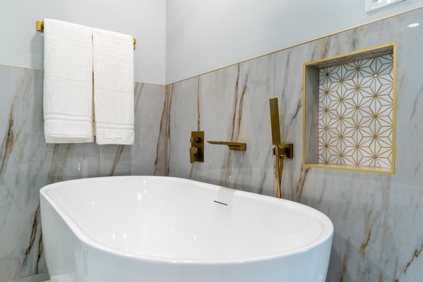 Glass, Gold, and Grace: Bathroom Remodel in Chino, CA by We The People - Designing a bathroom that feels modern yet comfortable is always a balancing act. This bathroom remodel in Chino, CA aimed to deliver exactly that—sleek lines, thoughtful details, and a layout that supports daily use.
The bathroom design started with large-format marble-look tile, which gave the room a unified, continuous look while visually expanding the space. The frameless glass shower kept sightlines open, and gold-toned hardware added warmth without overpowering the palette. Integrated tile niches brought smart storage into the mix, while the floating vanity and standalone tub introduced structure and softness at once.
We The People Construction team led the process from layout to final detail to make sure every feature aligned with the project’s design intent.
Bathroom remodeling is most successful when form and function move together—and this space reflects that balance in every detail. Ready to create something modern and timeless? We’d love to design and build your next bathroom. Glass, Gold, and Grace: Bathroom Remodel in Chino, CA by We The People - Designing a bathroom that feels modern yet comfortable is always a balancing act. This bathroom remodel in Chino, CA aimed to deliver exactly that—sleek lines, thoughtful details, and a layout that supports daily use.
The bathroom design started with large-format marble-look tile, which gave the room a unified, continuous look while visually expanding the space. The frameless glass shower kept sightlines open, and gold-toned hardware added warmth without overpowering the palette. Integrated tile niches brought smart storage into the mix, while the floating vanity and standalone tub introduced structure and softness at once.
We The People Construction team led the process from layout to final detail to make sure every feature aligned with the project’s design intent.
Bathroom remodeling is most successful when form and function move together—and this space reflects that balance in every detail. Ready to create something modern and timeless? We’d love to design and build your next bathroom.