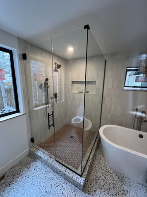 Minimalist Shower Enclosure - Wall hinged door, inline panel and return. Matte black hardware and ultra clear glass. Minimalist Shower Enclosure - Wall hinged door, inline panel and return. Matte black hardware and ultra clear glass.