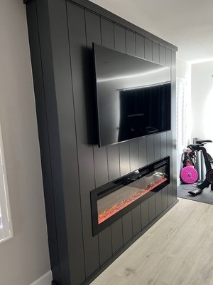 Fireplace Accent Wall - We recently completed a stunning fireplace accent wall project in a primary bedroom in Temecula, blending modern design with cozy elegance. The transformation began with framing the accent wall to create the perfect structure for a seamless look. We installed vertical nickel gap shiplap, a timeless design element, and finished it with a bold black paint that adds depth and sophistication to the room. At the heart of the wall is a built-in electric fireplace, offering both warmth and ambiance. The result is a striking focal point that elevates the master bedroom into a luxurious retreat. Fireplace Accent Wall - We recently completed a stunning fireplace accent wall project in a primary bedroom in Temecula, blending modern design with cozy elegance. The transformation began with framing the accent wall to create the perfect structure for a seamless look. We installed vertical nickel gap shiplap, a timeless design element, and finished it with a bold black paint that adds depth and sophistication to the room. At the heart of the wall is a built-in electric fireplace, offering both warmth and ambiance. The result is a striking focal point that elevates the master bedroom into a luxurious retreat.