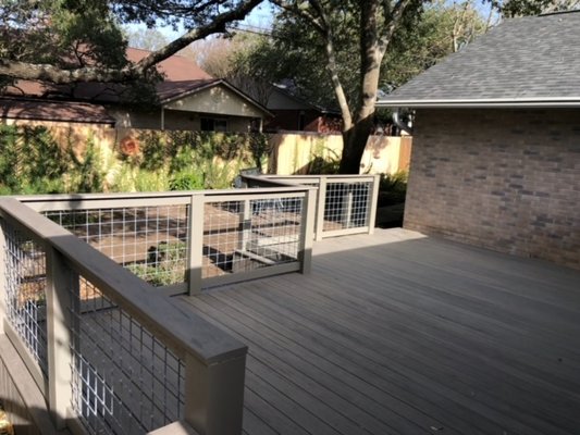 Hassmann Deck - We came in and removed the existing deck along with the 3 layers of bricks that the deck was standing on. Added crushed granite to help prevent moisture from rotting out the deck frame. Re-framed the deck with Prime Pressure Treated lumber and installed Timber Tech Pro Deck Boards (Ashwood) which comes with a 30 Year Warranty on the Deck Boards. The railing we used pressure treated posts and wrapped them in vinyl and painted to match the Ashwood Deck Boards. For the handrails we used the Timber Tech Deck Boards for the handrail which gave it a more beautiful and matching look for the deck. the customer requested cattle panel instead of balusters which is another unique feature on this deck.
