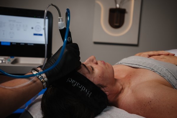 Hydrafacials - A Hydrafacial is a closed-loop system that vacuums out the gunk (dirt, make-up). It offers pain-free extractions and exfoliation, then infuses nourishing ingredients into your skin. You will have the best skin of your life when you experience the Hydrafacial magic wand. Tighten, Brighten and Hydrate all in one facial. You have to get it to get it! Hydrafacials - A Hydrafacial is a closed-loop system that vacuums out the gunk (dirt, make-up). It offers pain-free extractions and exfoliation, then infuses nourishing ingredients into your skin. You will have the best skin of your life when you experience the Hydrafacial magic wand. Tighten, Brighten and Hydrate all in one facial. You have to get it to get it!