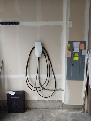 EV charger - This is a Tesla Wall Connector installation in a detached garage.