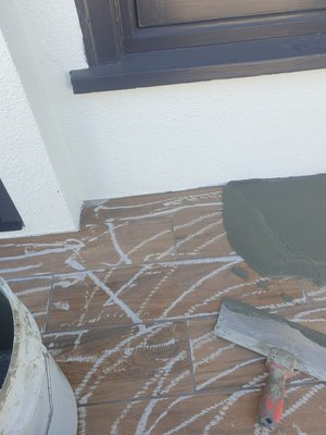 Tiled deck with out removing the tile  waterproofing Los Angeles￼ - Grind existing tile￼￼
Apply fireproof coating
Apply prep coat
Apply fiberglass math 
Apply bonder resin
Apply texture coat 
Apply waterproof top coat