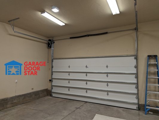 HI-Lift - This garage suffered from garage doors "being in the way". New insulated garage doors installed with High Lift tracks and side mount opener to allow as much clearance as possible.