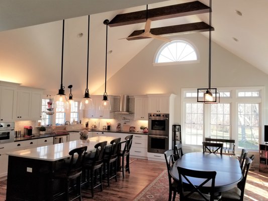 Family Room Addition to a Bowed Roof Colonial. - The Whitneys wanted to expand their cramped kitchen/living area into a large family room over their existing garage so that they could host large family gatherings.