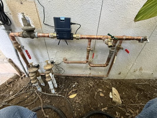 Moen Flo Smart Water Shutoff Installation & Water Line Reconfiguration - We upgraded this property’s water system by installing a new Moen Flo Smart Water Monitor and Automatic Shutoff Valve to provide leak detection and emergency water shutoff protection.

As part of the installation, we reconfigured the main water distribution piping to properly separate the domestic water supply from the irrigation system. Independent shutoff valves were installed for both systems, allowing each line to be isolated for maintenance, repairs, or emergencies without disrupting the entire property’s water service.

The project included:
• Installation of a Moen Flo Smart Water Shutoff System
• Copper water line modifications and rerouting
• Separation of domestic and irrigation water supplies
• Installation of dedicated isolation valves
• System testing and verification for proper operation

The customer now has greater control over their water system, improved leak protection, and easier access for future maintenance.

Completed by Rapid Relief Plumbing
CSLB #1145129