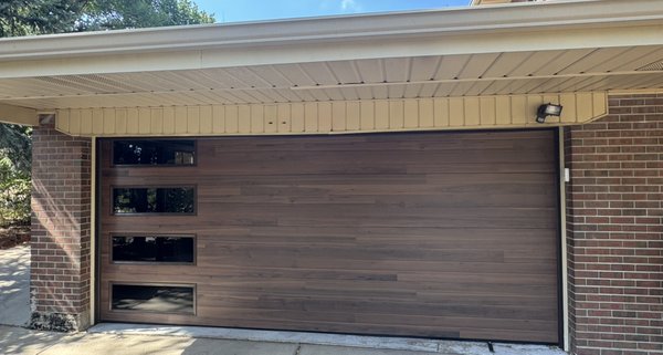 Wood Tone Steel Garage Door Replacement - Another classy upgrade to the community. Thank you for letting us be a part of your project. Wood Tone Steel Garage Door Replacement - Another classy upgrade to the community. Thank you for letting us be a part of your project.