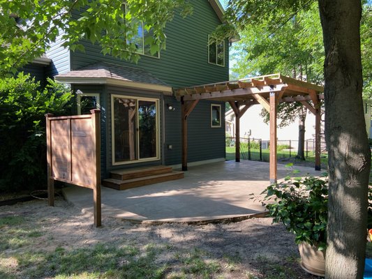 Pergola, Privacy Fence and Steps - This customer accessorized a new cement patio with a pergola, privacy fence and matching steps for the patio door.  These were constructed with cedartone treated lumber.