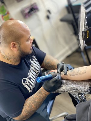 Tattoos by Tommy Tattz - Introducing Tommy, the owner and lead artist of our studio, with over 15 years of expertise in tattooing and exceptional customer service. Specializing in oriental art, realism, and black & grey tattoos, Tommy combines precision and artistry to create truly remarkable pieces. Explore his portfolio and stay connected by following him on Instagram @Tommy_Tattz for the latest updates and inspiration. Tattoos by Tommy Tattz - Introducing Tommy, the owner and lead artist of our studio, with over 15 years of expertise in tattooing and exceptional customer service. Specializing in oriental art, realism, and black & grey tattoos, Tommy combines precision and artistry to create truly remarkable pieces. Explore his portfolio and stay connected by following him on Instagram @Tommy_Tattz for the latest updates and inspiration.