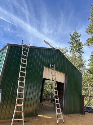Steel Shop Twain Harte - This was a 30 foot by 65 foot steel shop build. Everything was permitted and inspected. Client requested side shop door as well as double pane windows as well as, he also requested a welded set of hoist rings at top of arches.