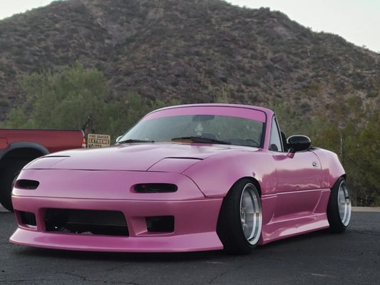 Mazda Miata - Hexis Jellybean Pink - 1998 Mazda Miata
color: Hexis Jellybean Pink
full wrap on this little miata. giving an old car another lease on life by taking an old beater and transforming it into a show car.
the car was in rough shape, alot of sanding was required along with having to have the car primered to cover exposed body filler. body kit was then fitted and being polyurethane, it had to be rigorously preped for wrap. gel coat was sanded off and a layer of primer was used to help bond the material to the plastic. the car was wrapped completely under all the overfenders to ensure the most coverage possible. after the wrap the miata was set up with a 5 year ceramic coating to ensure it stays looking great. miata was then given a Stylish Nostalgia banner at owners request. the car was later brought back to have the hard top wrapped and coated to match. Mazda Miata - Hexis Jellybean Pink - 1998 Mazda Miata
color: Hexis Jellybean Pink
full wrap on this little miata. giving an old car another lease on life by taking an old beater and transforming it into a show car.
the car was in rough shape, alot of sanding was required along with having to have the car primered to cover exposed body filler. body kit was then fitted and being polyurethane, it had to be rigorously preped for wrap. gel coat was sanded off and a layer of primer was used to help bond the material to the plastic. the car was wrapped completely under all the overfenders to ensure the most coverage possible. after the wrap the miata was set up with a 5 year ceramic coating to ensure it stays looking great. miata was then given a Stylish Nostalgia banner at owners request. the car was later brought back to have the hard top wrapped and coated to match.