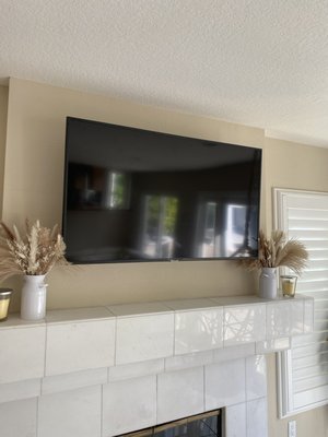 TV installation and outlet relocation using fixed mount above fireplace - 55” TV installation above fireplace. fixed mount was used with toggle bolts due to not having available studs because of chimney. I also ran cabling through the drywall from original point of origin so cables would be discreet and hidden. TVs can be fitted to almost any wall in your home using correct rated hardware and installation techniques. Aesthetically pleasing finish every time.