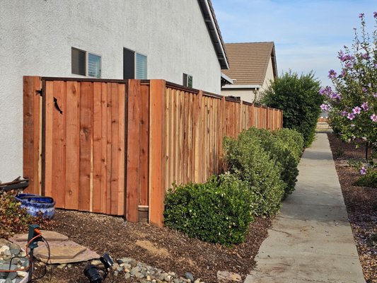 Picture frame fence installation - This fence features overlapping boards for added durability, and each side of the fence looks identical. This is ideal for fences on shared boundary lines.