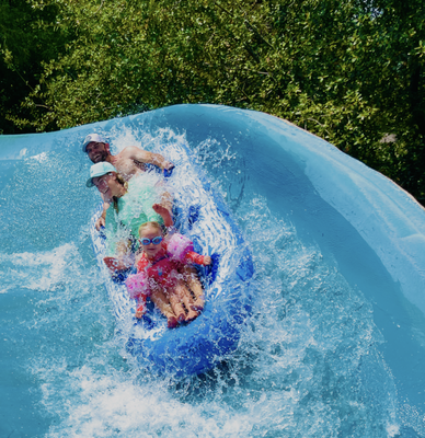 The Raging River - Race through churning rapids on single, double, or triple tubes — bounce off turns, drop into whirlpools, and slide over 210 feet of splashing thrills. Cool off and feel the rush.
*MAX WT. SINGLE TUBE: 250 LBS
*MAX WT. DOUBLE RIDERS: 400 LBS
*MAX WT. TRIPLE RIDERS: 600 LBS The Raging River - Race through churning rapids on single, double, or triple tubes — bounce off turns, drop into whirlpools, and slide over 210 feet of splashing thrills. Cool off and feel the rush.
*MAX WT. SINGLE TUBE: 250 LBS
*MAX WT. DOUBLE RIDERS: 400 LBS
*MAX WT. TRIPLE RIDERS: 600 LBS