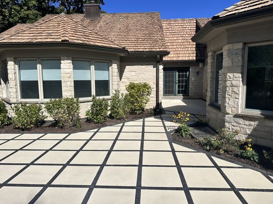 Modern Masterpiece in Highland Park: Award-Nominated Patio Design - The Bravo's Landscape proudly presents a cutting-edge paver patio that redefines outdoor elegance. Our expert design and installation teams crafted a striking grid pattern using large, sleek Arcana slabs from Unilock in Avorio, perfectly complemented by black Copthorne paver inlays in Basalt.
This innovative design caught the attention of Unilock, earning a prestigious nomination for 'Best Use of Slabs' in their coveted Awards of Excellence. Our team's dedication to creativity and excellence has resulted in a truly one-of-a-kind outdoor space that sets a new standard for modern outdoor design. Modern Masterpiece in Highland Park: Award-Nominated Patio Design - The Bravo's Landscape proudly presents a cutting-edge paver patio that redefines outdoor elegance. Our expert design and installation teams crafted a striking grid pattern using large, sleek Arcana slabs from Unilock in Avorio, perfectly complemented by black Copthorne paver inlays in Basalt.
This innovative design caught the attention of Unilock, earning a prestigious nomination for 'Best Use of Slabs' in their coveted Awards of Excellence. Our team's dedication to creativity and excellence has resulted in a truly one-of-a-kind outdoor space that sets a new standard for modern outdoor design.