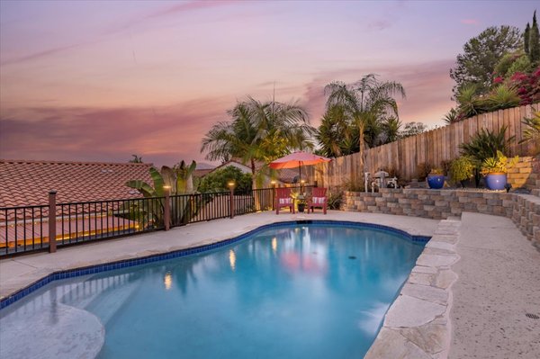 1096 Ponderosa Avenue, San Marcos, CA 92069 - Gorgeous single-story 4 bedroom home with indoor/outdoor living entertainment area with stunning panoramic mountain views from the upper level pool. The private backyard with swimming pool and seating to enjoy the evening lights. The covered patio with relaxing spa and lounge area for entertaining. Water feature that can easily become a koi pond or a firepit. You decide. Two car garage with 3 car driveway, perfect for RV, Trailer or Toy car side parking. Interior upgrades include granite counter tops in kitchen, upgraded cabinets, custom built breakfast bar with storage. Remodeled bathrooms and porcelain tile and laminate wood flooring. Central Air condition and whole house fan to cool down the house in the summer, fully owned 28 solar pannels, Tankless water heater, and all dual pane vinyl windows. Ideally located between 15 and 78 fwys. Minutes to schools, shopping, restaurants, colleges, hospitals, and surrounded by parks.
