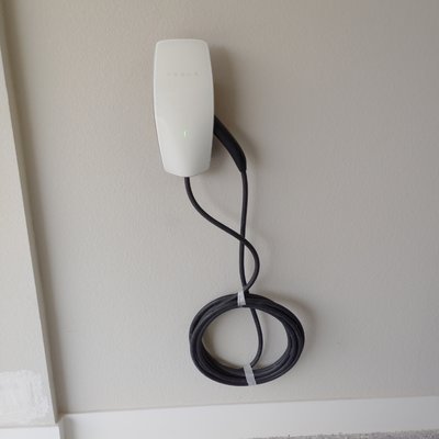 Electric EV wall charger - Installed power supply and customer supplied wall charger for Tesla Electric Car. Electric EV wall charger - Installed power supply and customer supplied wall charger for Tesla Electric Car.
