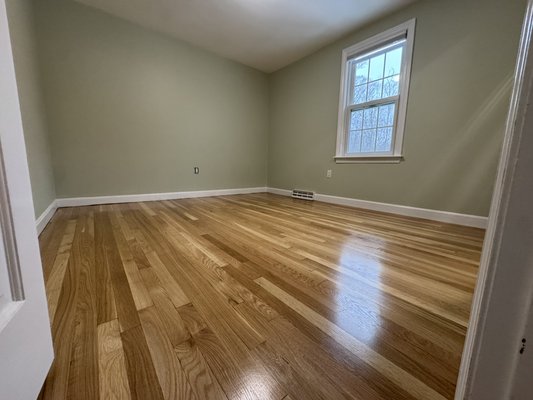 Hardwood Floor Refinishing, Natural 02/26 - The second floor of this home had been covered with old gray office-style carpet, which we removed, exposing beautiful oak floors underneath. After sanding the floors we applied a sealer, and 3 topcoats of water based polyurethane. The final result left our client with a beautiful floor which had consistent color throughout the whole second floor.