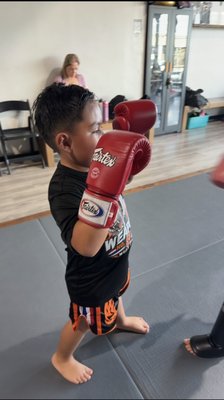 Kids Muay Thai - Weapon No. 8 Muay Thai Kids Classes help children build confidence, discipline, coordination, fitness, and real Muay Thai skills in a structured, positive environment. Our coaches focus on proper technique, respect, focus, and having fun while helping every student progress at their own pace. Ages 5–12. Beginners welcome! Kids Muay Thai - Weapon No. 8 Muay Thai Kids Classes help children build confidence, discipline, coordination, fitness, and real Muay Thai skills in a structured, positive environment. Our coaches focus on proper technique, respect, focus, and having fun while helping every student progress at their own pace. Ages 5–12. Beginners welcome!