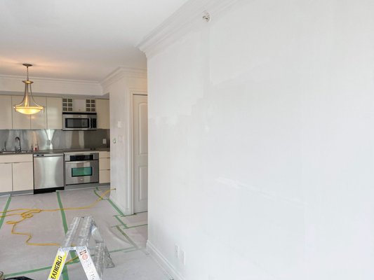 Repainting of a condominium unit at the corner of Hamilton St. and Robson St. in downtown Vancouver, BC - The condominium unit was repainted with a fresh, new coat of paint. It included the living room, kitchen, dining area and bathroom.