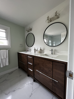 Bathroom in Classic Style With Double Vanity - Bathroom in a classic style in wood color vanity with a double sink and a mosaic bathtub and a toilet wall Bathroom in Classic Style With Double Vanity - Bathroom in a classic style in wood color vanity with a double sink and a mosaic bathtub and a toilet wall