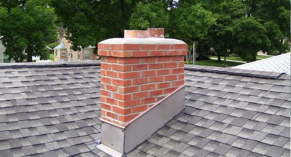 Chimney Masonry Repair 2020 - Demolished At the block fireplace chimney, at the right side of the home, we will erect scaffolding to access the entire chimney. The top four courses of 8" CMU blocks and 2 courses of 4" CMU solid blocks will be completely demolished and removed. The chimney top will be rebuilt to the original size and dimensions using a combination of brand new 8" CMU blocks and brand new bricks. 3500 PSI concrete will be poured in place atop the chimney crown; beveled and sloped for runoff, and finished with a magnesium trowel. At the roof line metal flashing, lacking a rig-let; we will remove the aluminum. New 2" rig-let channels will be ground into the joints of the block work, stepping with the courses and the pitch of the roof. Brand new aluminum counter-flashing will be bent and fabricated on site and installed into the rig-let channel. The top seam will be grouted into the blocks. The bottom seam will be neatly taped and mucked with a fibered roofers cement. At the shoulder of the chimney, a new thermal tread piece fitted with a 2" drip-edge will be thin-set in place with ardex. The entire existing stucco surface will be wrapped with galvanized wire lathe fixed in place with galvanized nails from a .27 powder actuated gun. After the entire chimney is wired, we will apply two coats of stucco finished in a color and texture selected by the homeowner. A new metal vent cap and a new stainless flue cap will be installed. At completion of all proposed work, we will leave the site in a neat and clean condition. Chimney Masonry Repair 2020 - Demolished At the block fireplace chimney, at the right side of the home, we will erect scaffolding to access the entire chimney. The top four courses of 8" CMU blocks and 2 courses of 4" CMU solid blocks will be completely demolished and removed. The chimney top will be rebuilt to the original size and dimensions using a combination of brand new 8" CMU blocks and brand new bricks. 3500 PSI concrete will be poured in place atop the chimney crown; beveled and sloped for runoff, and finished with a magnesium trowel. At the roof line metal flashing, lacking a rig-let; we will remove the aluminum. New 2" rig-let channels will be ground into the joints of the block work, stepping with the courses and the pitch of the roof. Brand new aluminum counter-flashing will be bent and fabricated on site and installed into the rig-let channel. The top seam will be grouted into the blocks. The bottom seam will be neatly taped and mucked with a fibered roofers cement. At the shoulder of the chimney, a new thermal tread piece fitted with a 2" drip-edge will be thin-set in place with ardex. The entire existing stucco surface will be wrapped with galvanized wire lathe fixed in place with galvanized nails from a .27 powder actuated gun. After the entire chimney is wired, we will apply two coats of stucco finished in a color and texture selected by the homeowner. A new metal vent cap and a new stainless flue cap will be installed. At completion of all proposed work, we will leave the site in a neat and clean condition.