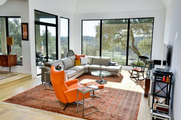 Major Renovation - Austin - Two key features with this project were the removal of a fireplace, mantle and chimney encased with windows overlooking the pool, and a complete renovation of the kitchen and laundry area to modernize and dramatically improve functionality with a new layout and cabinetry with all the gadgets. White carrara quartz countertops with European lacquer white and dark grey cabinets provide both the functionality needed in this high-use kitchen and a beautiful modern integration with the mid-century theme for living, dining and breakfast areas. Moving the oven from the island to the wall allows for use of the island as a prep area and the range cooktop to be vented to the outdoors via a wall hood. Removing the outdated built-in brick planter at the entry, new flooring, and new windows truly beautify the home, opening but keeping the general floor plan of the original home design. Major Renovation - Austin - Two key features with this project were the removal of a fireplace, mantle and chimney encased with windows overlooking the pool, and a complete renovation of the kitchen and laundry area to modernize and dramatically improve functionality with a new layout and cabinetry with all the gadgets. White carrara quartz countertops with European lacquer white and dark grey cabinets provide both the functionality needed in this high-use kitchen and a beautiful modern integration with the mid-century theme for living, dining and breakfast areas. Moving the oven from the island to the wall allows for use of the island as a prep area and the range cooktop to be vented to the outdoors via a wall hood. Removing the outdated built-in brick planter at the entry, new flooring, and new windows truly beautify the home, opening but keeping the general floor plan of the original home design.